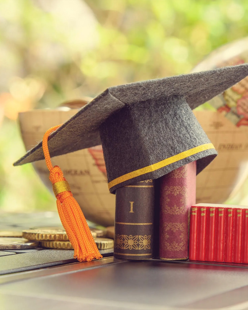graduate cap and books